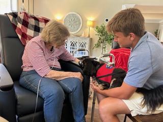 Service dog visiting an elderly resident